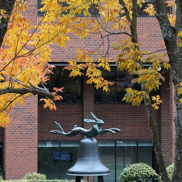 Hare and Bell sculpture in Fountain Square, surround by trees with fall leaf colors